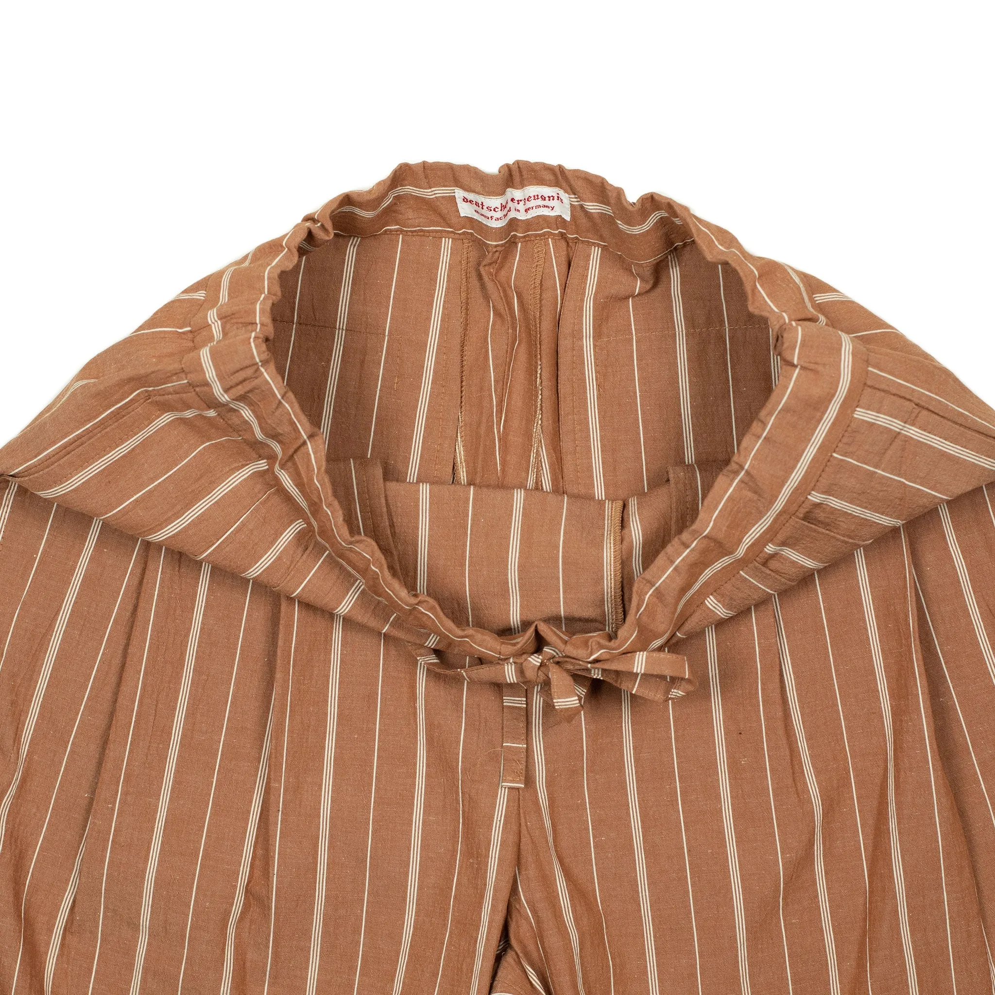Pleated drawstring trousers in burnt orange and white striped cotton/linen