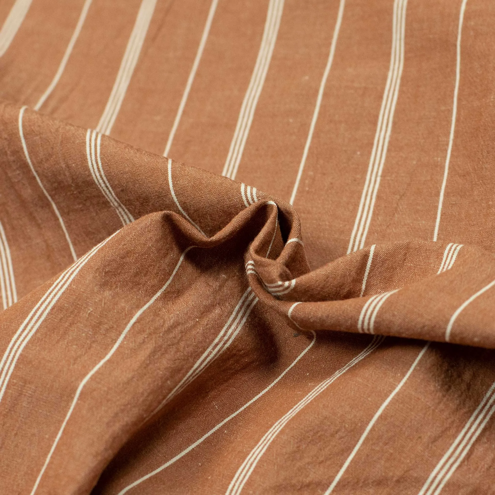 Pleated drawstring trousers in burnt orange and white striped cotton/linen